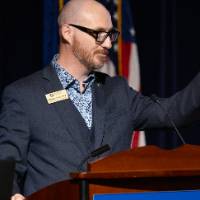 Nathan Kemler speaking at podium